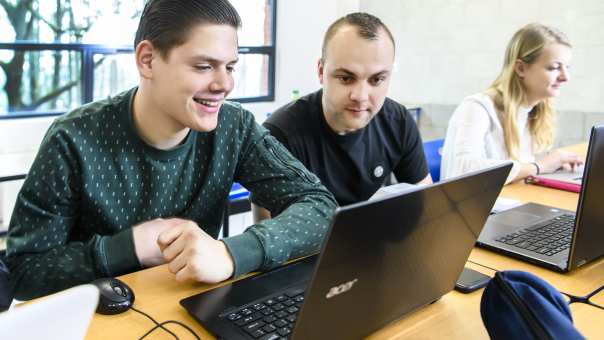 studenten lachend met laptop