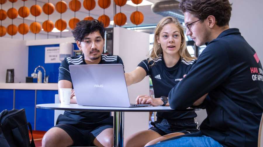 sportkunde liggende foto studenten overleggen met docent aan tafel randy en carlijn en docent lars 2022