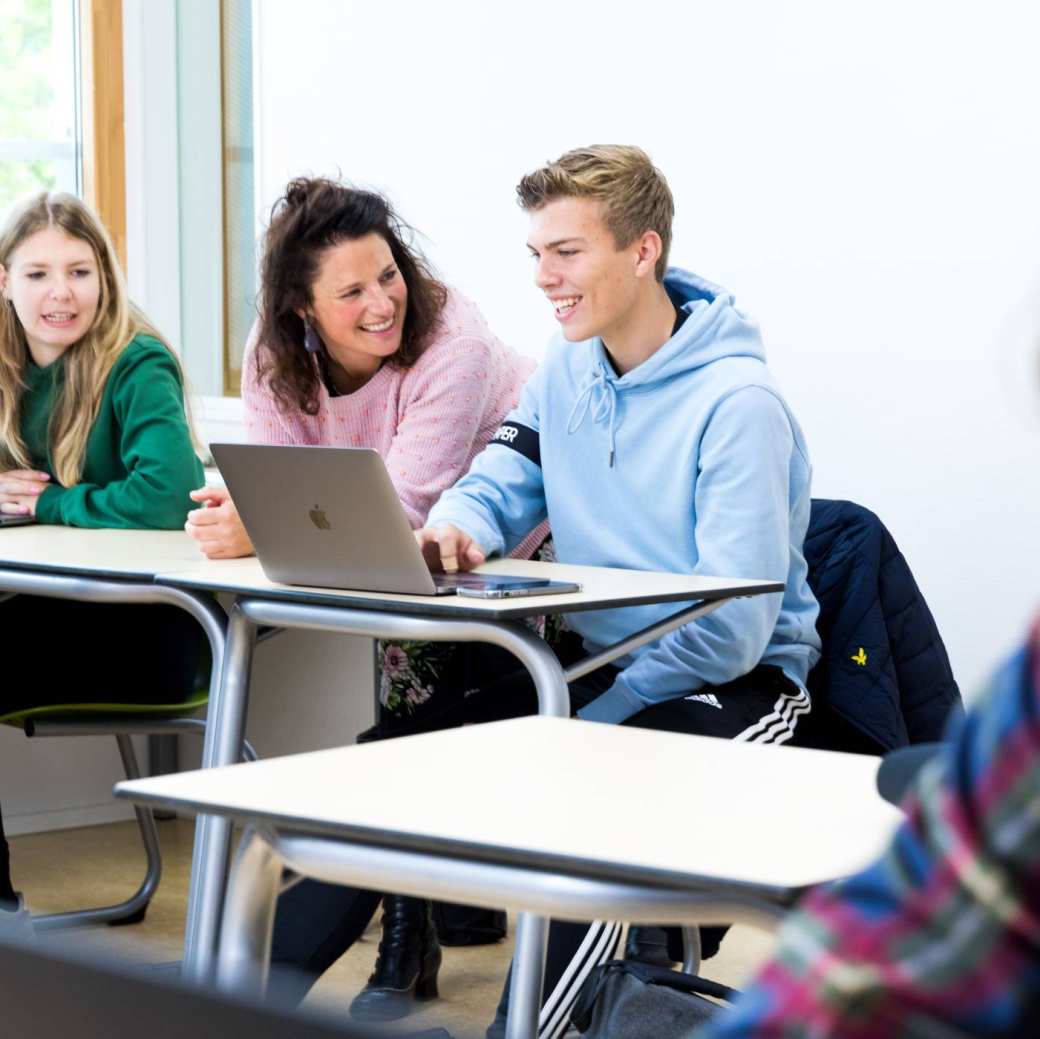 Pabo-ALO studenten sparren met hun docent in Pabo lokaal, achter de laptop.