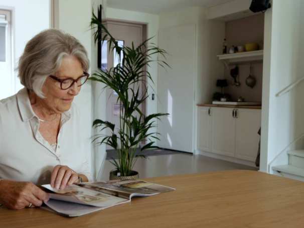 Dames leest krant in empathische woning