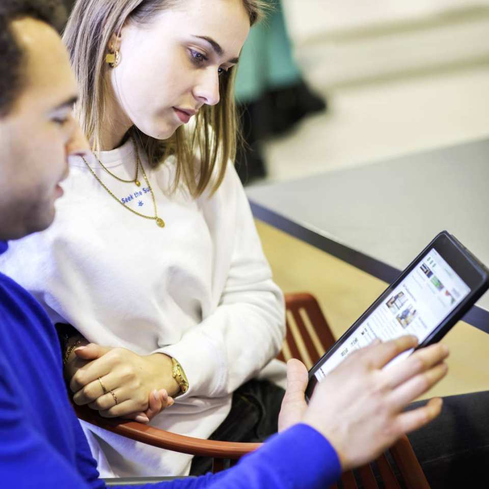 in gesprek kijkend op tablet