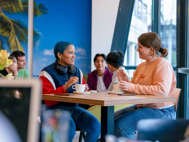 Students Noa, Chadionne, Tam, Diego, Nyugen and Andrei relaxing and drinking coffee in the Hangar on the Arnhem campus of HAN University of Applied Sciences.