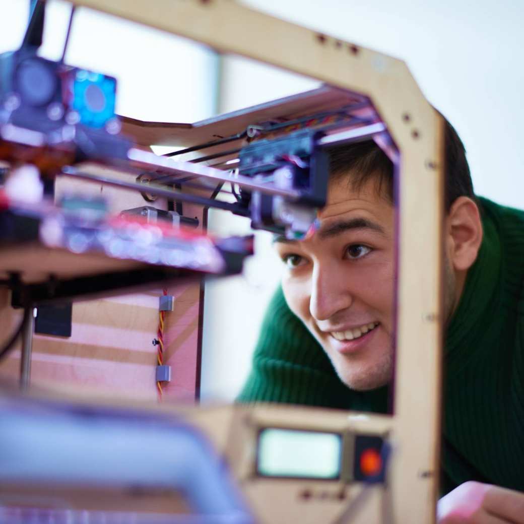 Man kijkt naar een 3d printer