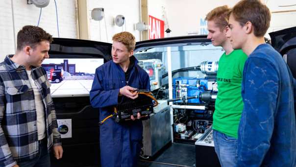 4 studenten voor de schterkant van de h2 demonstrator