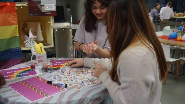 two girls painting their nails