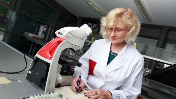 Cursist Anna Czerednik aan het werk met een microscoop