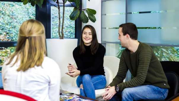 Studenten zittend op stoelen bij lage tafel verticaal