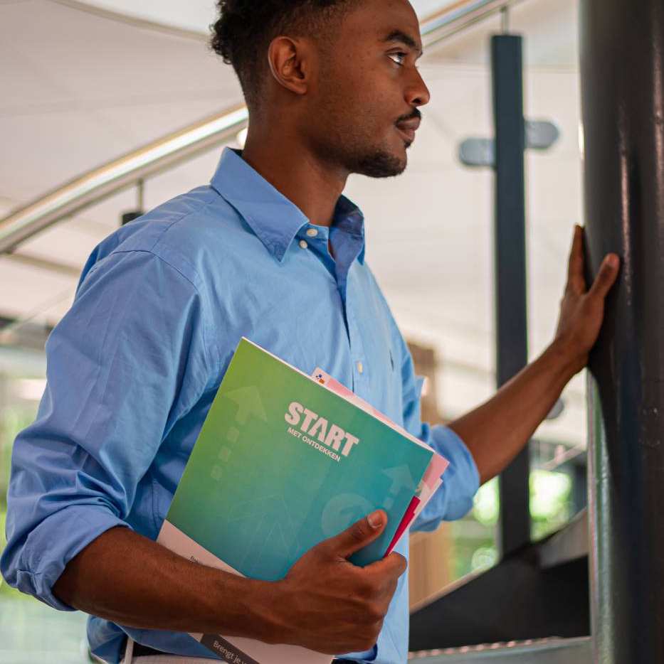 Student with book on staircase