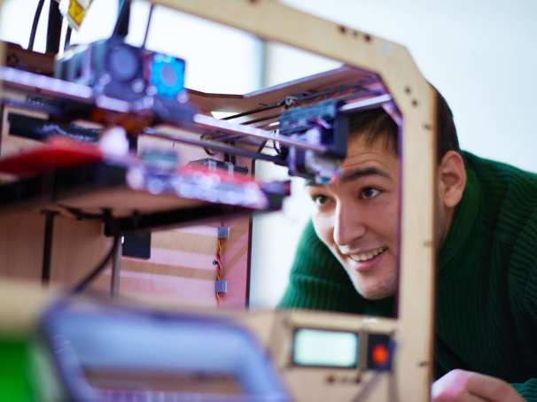 Man kijkt naar een 3d printer