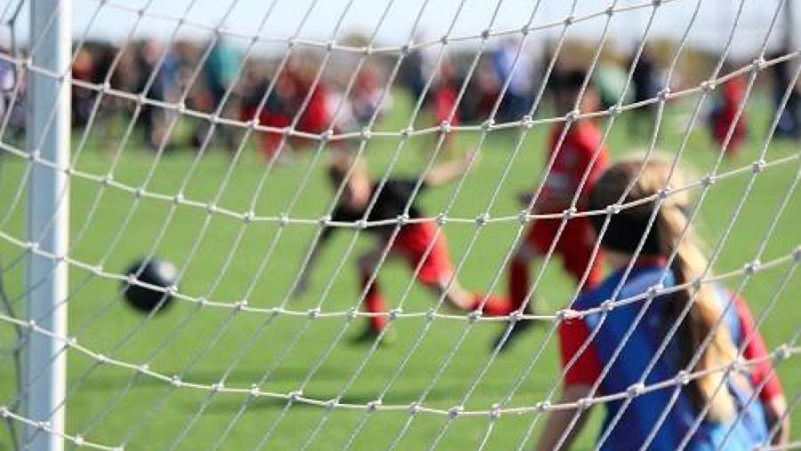 Voetbalwedstrijd, keepster in de goal