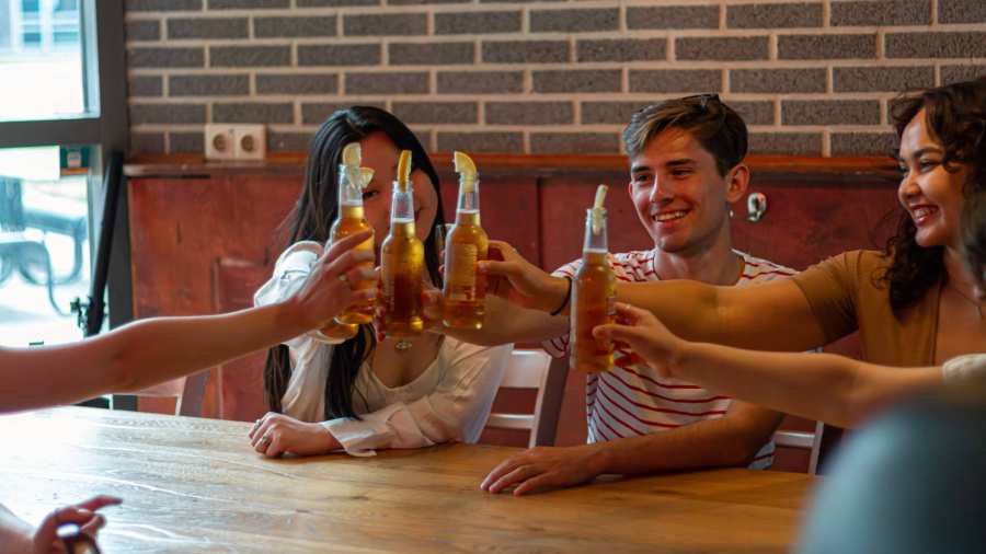 Students doing cheers with beer