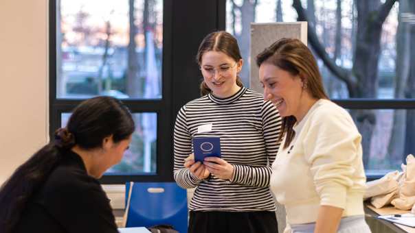 two students talking to their lecturer