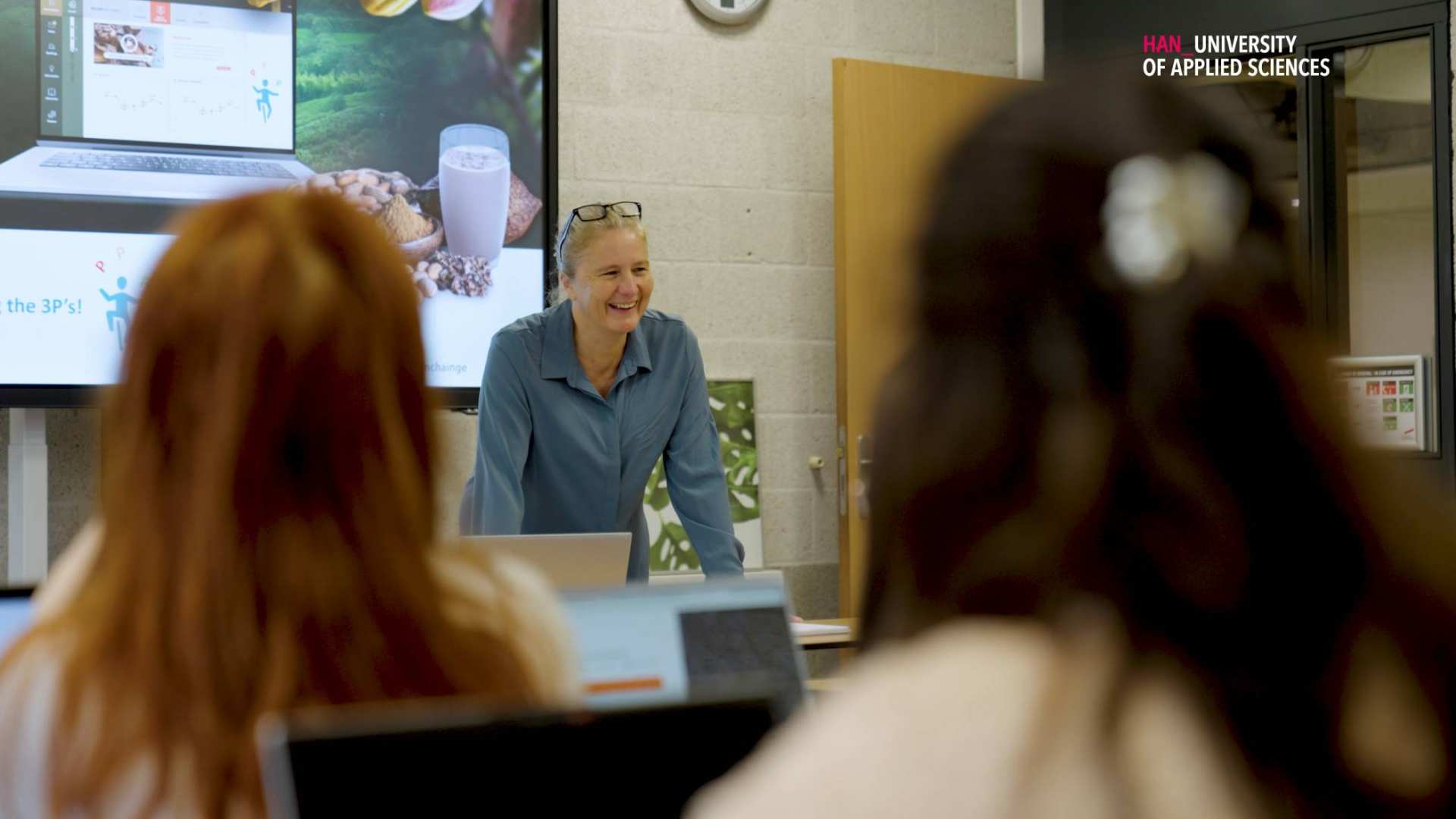 A lecturer smiling towards the class in a circular economy class