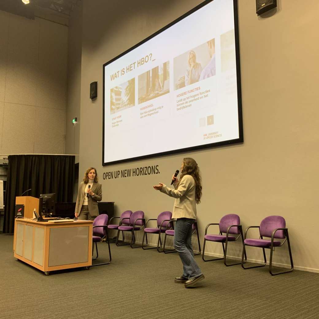 Presentatie in het auditorium, 2 vrouwen presenteren over het studeren op het hbo