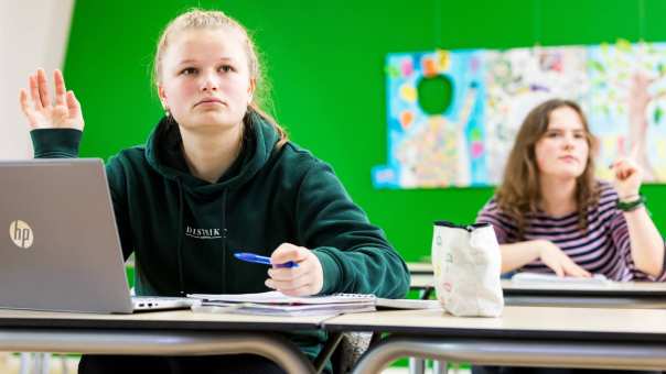 Close Up ALPO student met een groene hoodie met hand omhoog 