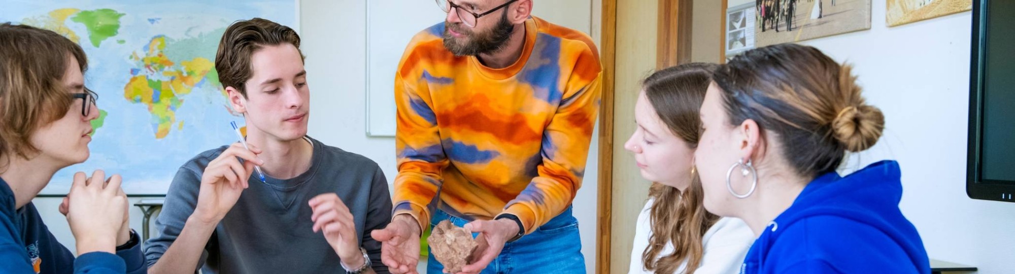 Twee studenten van HAN Leraar Aardrijkskunde lezen in de atlas.